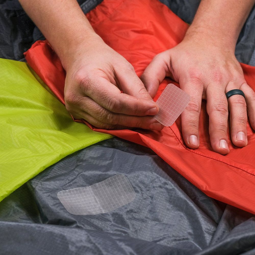 Gear Aid Tenacious Tape Silnylon Tent Patches being applied