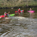 Three kayakers paddling on a river in Dulbin