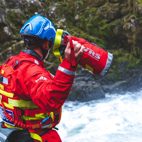 Rescue Responder about to throw WRS Chaos Thow Bag with rope into a whitewater river
